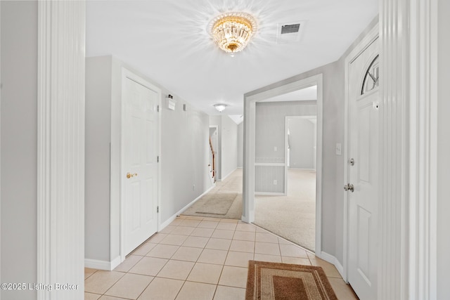 10431 Monticello Forest Cir, Jeffersontown, KY 40299 - hallway with light tile patterned flooring, baseboards, light carpet, and a chandelier