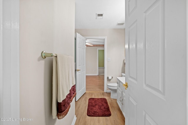 10431 Monticello Forest Cir, Jeffersontown, KY 40299 - bathroom with wood finished floors, toilet, and baseboards
