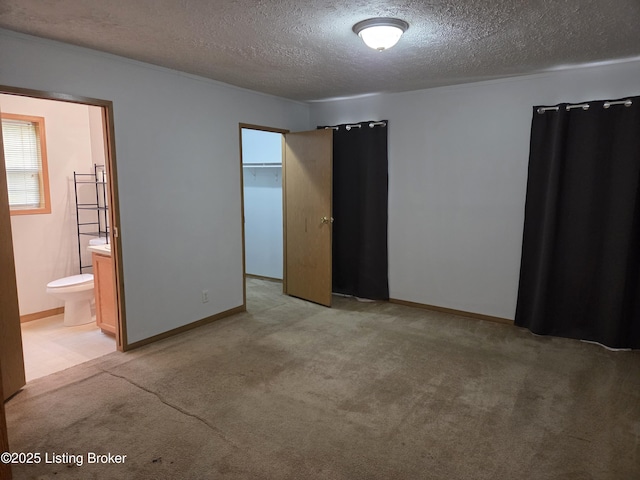 15008 Galston Blvd, Louisville, KY 40272 - unfurnished bedroom featuring a textured ceiling, light carpet, connected bathroom, and baseboards