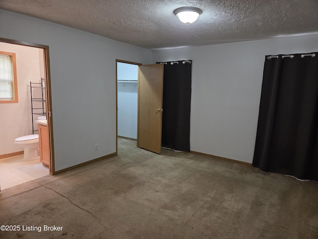 15008 Galston Blvd, Louisville, KY 40272 - unfurnished bedroom featuring a textured ceiling, light colored carpet, connected bathroom, and baseboards
