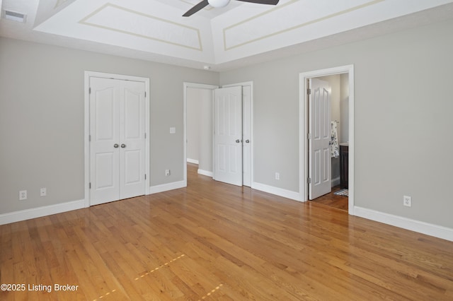 1020 Polley Dr, Bardstown, KY 40004 - unfurnished bedroom featuring light wood-style floors, multiple closets, baseboards, and ensuite bathroom