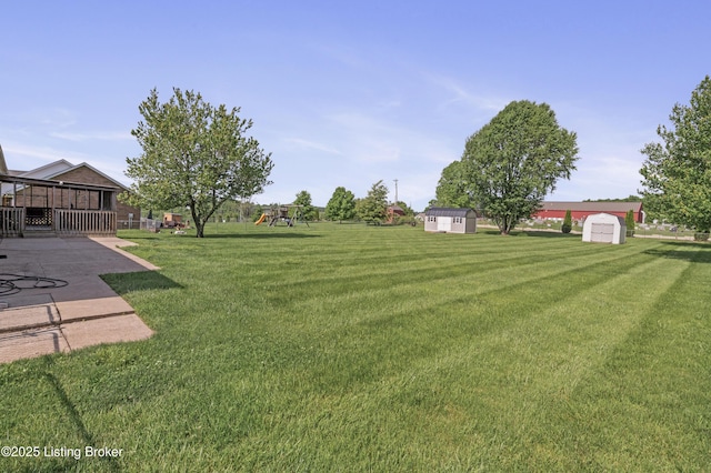 1020 Polley Dr, Bardstown, KY 40004 - view of green lawn with a playground and a patio area