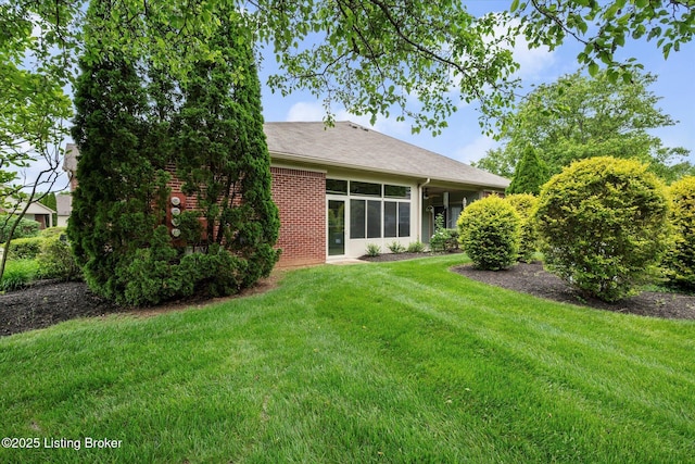 5010 Cotehele Pl, Louisville, KY 40241 - rear view of house featuring a lawn, brick siding, and a shingled roof