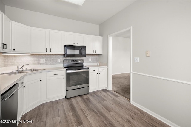 5010 Cotehele Pl, Louisville, KY 40241 - kitchen with stainless steel appliances, a sink, light wood finished floors, backsplash, and white cabinets
