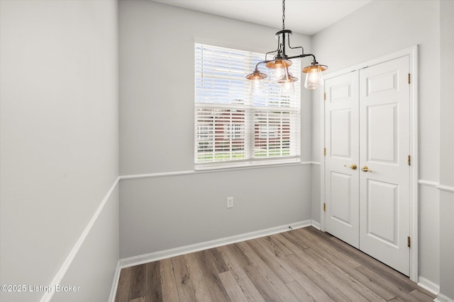 5010 Cotehele Pl, Louisville, KY 40241 - unfurnished dining area featuring wood finished floors, baseboards, and a chandelier