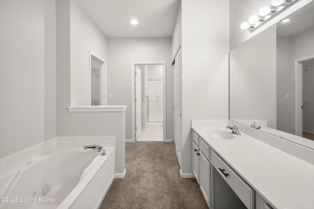 5010 Cotehele Pl, Louisville, KY 40241 - bathroom featuring a garden tub, vanity, baseboards, recessed lighting, and a walk in closet