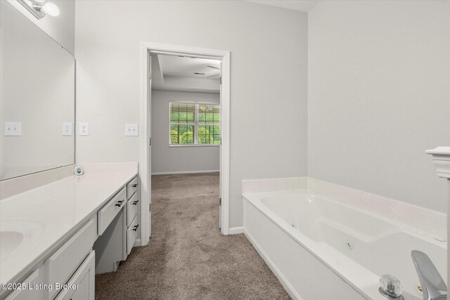 5010 Cotehele Pl, Louisville, KY 40241 - full bath featuring a jetted tub, vanity, carpet floors, and baseboards