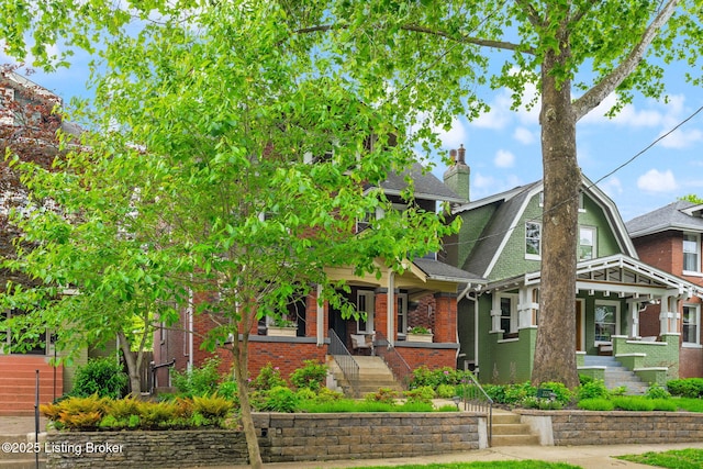 2220 Alta Ave, Louisville, KY 40205 - view of front of home featuring covered porch, brick siding, a shingled roof, a chimney, and stairway