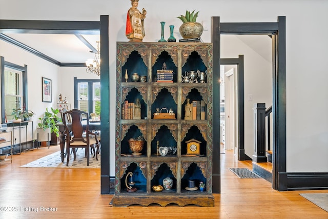 2220 Alta Ave, Louisville, KY 40205 - detailed view of wood finished floors, crown molding, and a chandelier