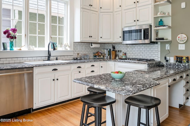 2220 Alta Ave, Louisville, KY 40205 - kitchen with appliances with stainless steel finishes, a sink, white cabinets, and a breakfast bar area