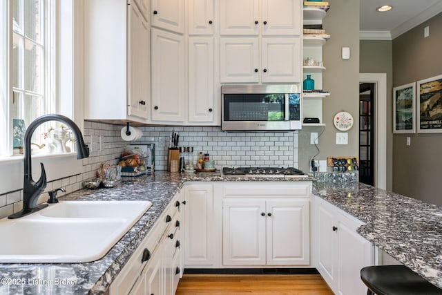 2220 Alta Ave, Louisville, KY 40205 - kitchen with appliances with stainless steel finishes, a sink, white cabinets, crown molding, and backsplash