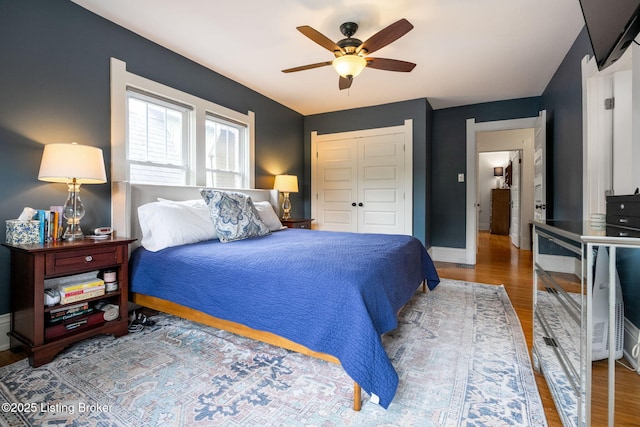 2220 Alta Ave, Louisville, KY 40205 - bedroom with wood finished floors, a closet, baseboards, and a ceiling fan