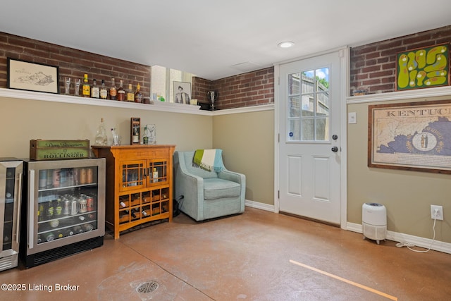 2220 Alta Ave, Louisville, KY 40205 - indoor dry bar with beverage cooler, finished concrete floors, baseboards, and brick wall