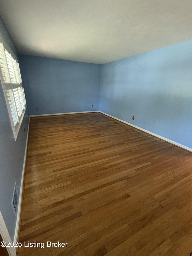 7406 Arapaho Dr, Louisville, KY 40214 - empty room with wood finished floors and baseboards