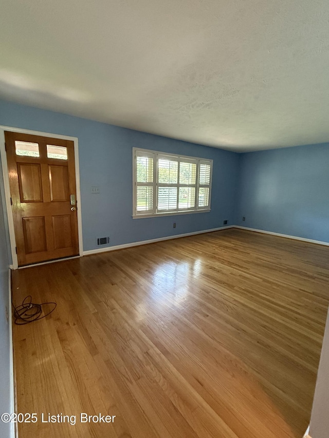 7406 Arapaho Dr, Louisville, KY 40214 - unfurnished living room featuring wood finished floors and baseboards