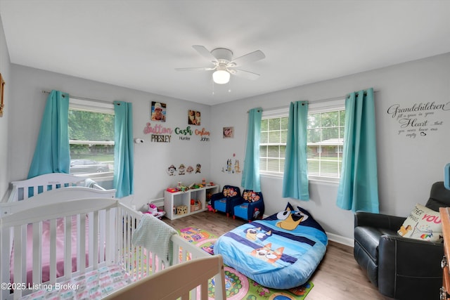 9926 Silverwood Ln, Louisville, KY 40272 - bedroom with multiple windows, wood finished floors, and a crib