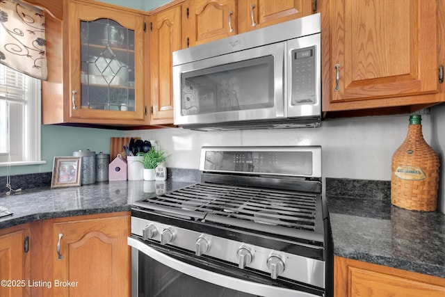 9926 Silverwood Ln, Louisville, KY 40272 - kitchen featuring stainless steel appliances, glass insert cabinets, and brown cabinetry