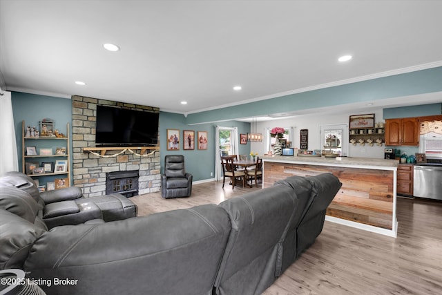 9926 Silverwood Ln, Louisville, KY 40272 - living room with crown molding, light wood finished floors, recessed lighting, a stone fireplace, and baseboards