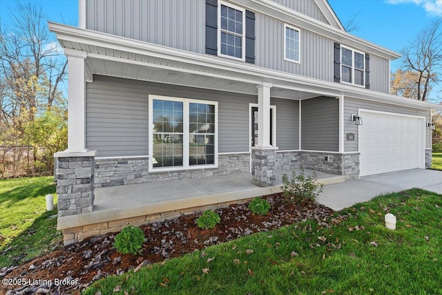 401 Sandy Cir, Elizabethtown, KY 42701 - craftsman-style house featuring covered porch, stone siding, board and batten siding, an attached garage, and concrete driveway