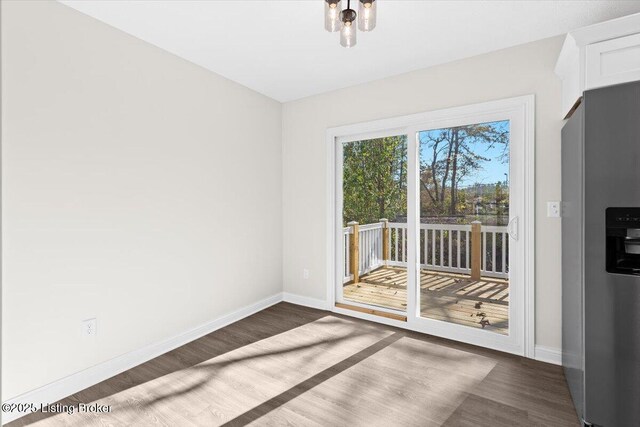 401 Sandy Cir, Elizabethtown, KY 42701 - unfurnished dining area featuring wood finished floors and baseboards
