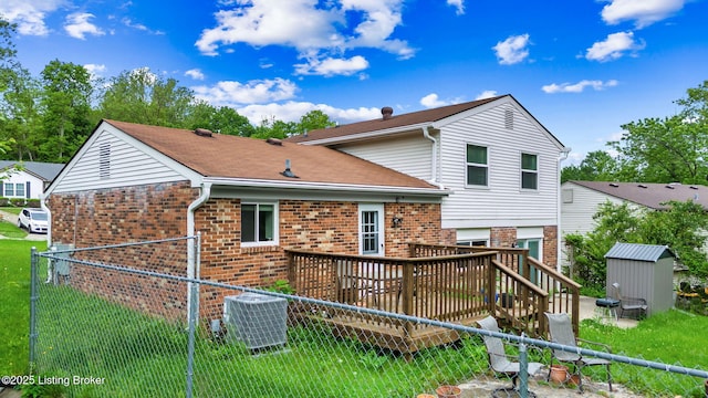 7333 W Orchard Grass Blvd, Crestwood, KY 40014 - back of house with brick siding, cooling unit, a shed, a wooden deck, and an outbuilding