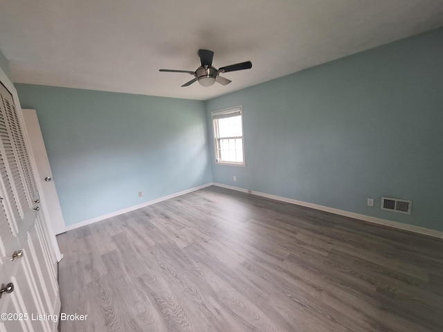 2508 Rhett Ct, Louisville, KY 40242 - spare room with wood finished floors, ceiling fan, and baseboards