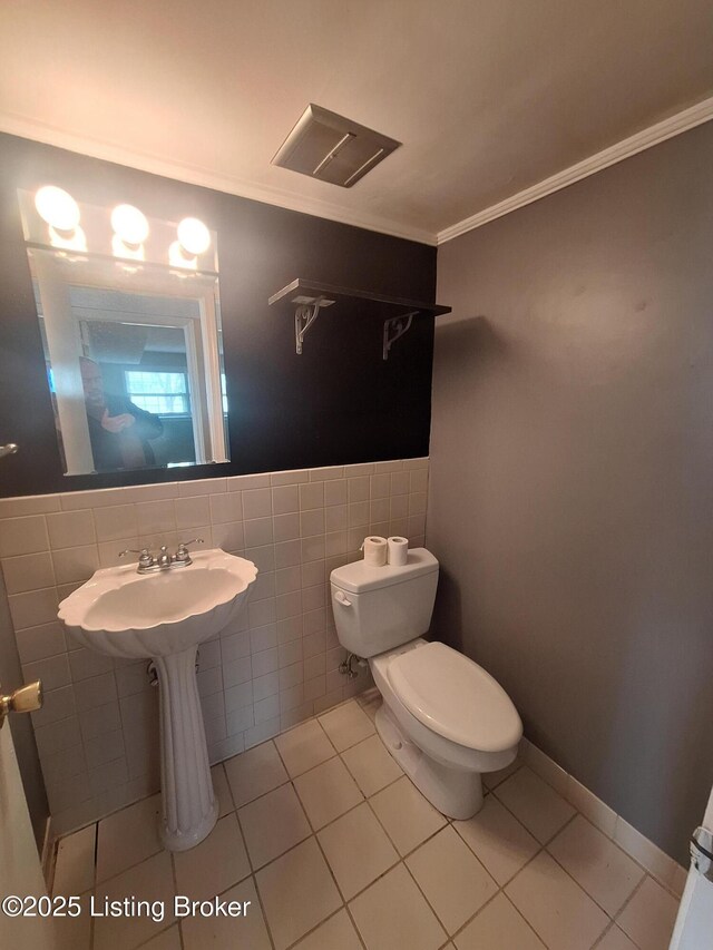 2508 Rhett Ct, Louisville, KY 40242 - half bath with tile walls, toilet, tile patterned floors, ornamental molding, and a wainscoted wall