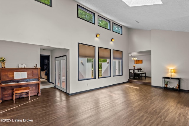 4308 Fence Pl, Louisville, KY 40241 - living area with plenty of natural light, wood finished floors, a towering ceiling, baseboards, and a textured ceiling
