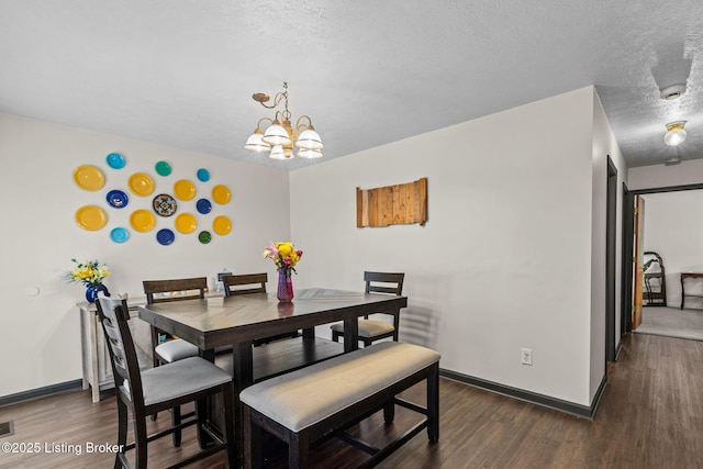4308 Fence Pl, Louisville, KY 40241 - dining room with a textured ceiling, a chandelier, dark wood-style floors, and baseboards