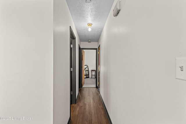 4308 Fence Pl, Louisville, KY 40241 - corridor with a textured ceiling, dark wood-style flooring, and baseboards