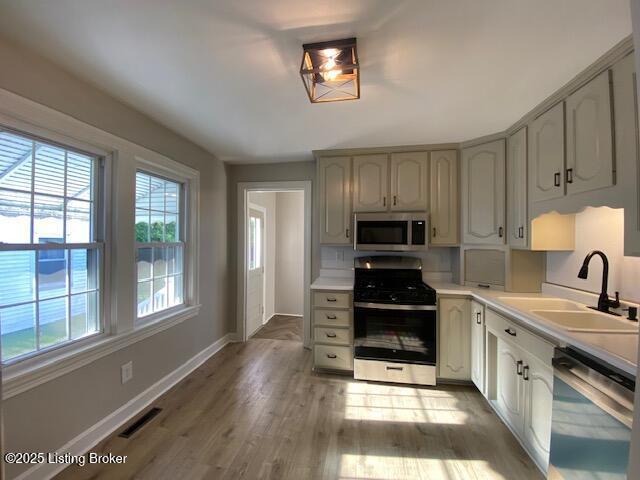 820 Johnson St, Bardstown, KY 40004 - kitchen with appliances with stainless steel finishes, a sink, healthy amount of natural light, and baseboards