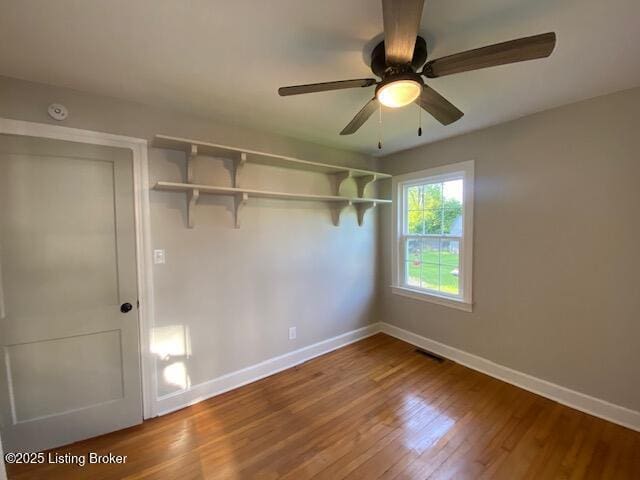 820 Johnson St, Bardstown, KY 40004 - unfurnished bedroom with baseboards, wood finished floors, and a ceiling fan