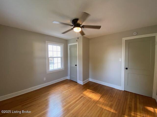 820 Johnson St, Bardstown, KY 40004 - unfurnished bedroom featuring baseboards, wood finished floors, and ceiling fan