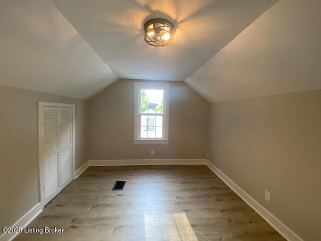 820 Johnson St, Bardstown, KY 40004 - additional living space with wood finished floors, lofted ceiling, and baseboards