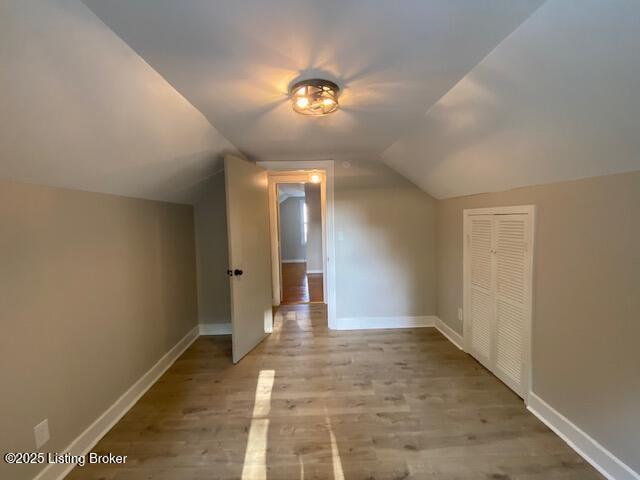 820 Johnson St, Bardstown, KY 40004 - additional living space with vaulted ceiling, wood finished floors, and baseboards