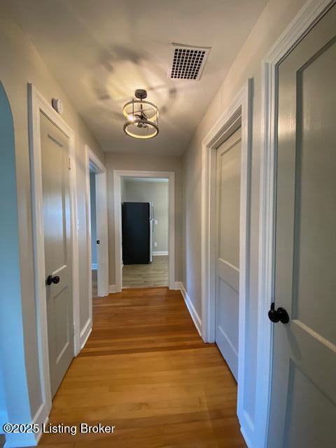 820 Johnson St, Bardstown, KY 40004 - hall featuring light wood-style flooring, baseboards, and arched walkways