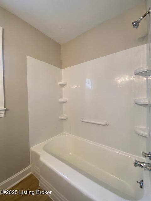 820 Johnson St, Bardstown, KY 40004 - bathroom featuring bathtub / shower combination, baseboards, and wood finished floors