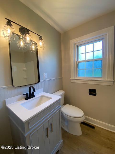 820 Johnson St, Bardstown, KY 40004 - bathroom with wood finished floors, wainscoting, vanity, and toilet