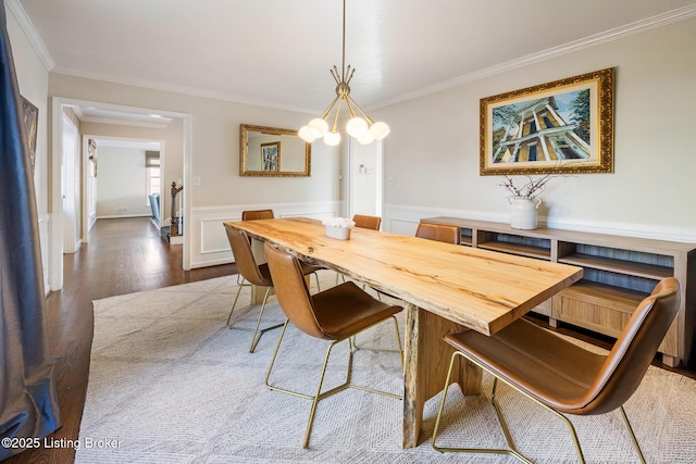 217 Sequoya Rd, Louisville, KY 40207 - dining room with ornamental molding, dark wood finished floors, a chandelier, and a wainscoted wall