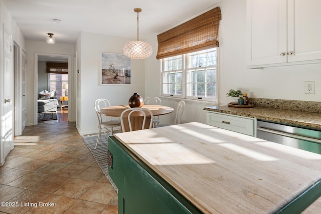 217 Sequoya Rd, Louisville, KY 40207 - dining area with baseboards and light stone finish floors