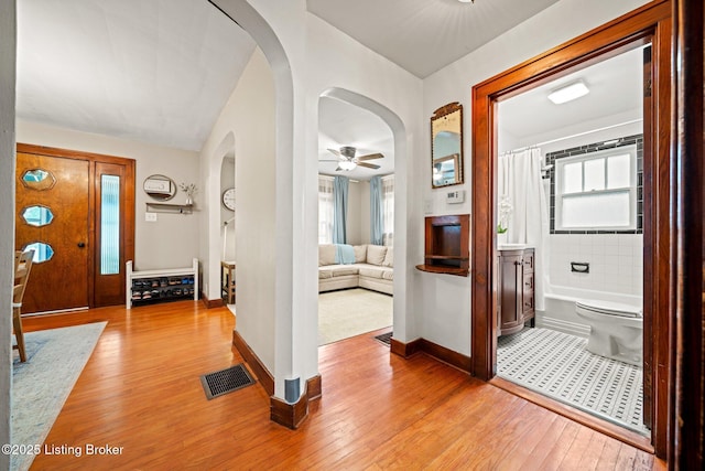 1883 Allgeier Ct, Louisville, KY 40213 - hall with arched walkways, light wood-type flooring, healthy amount of natural light, and baseboards