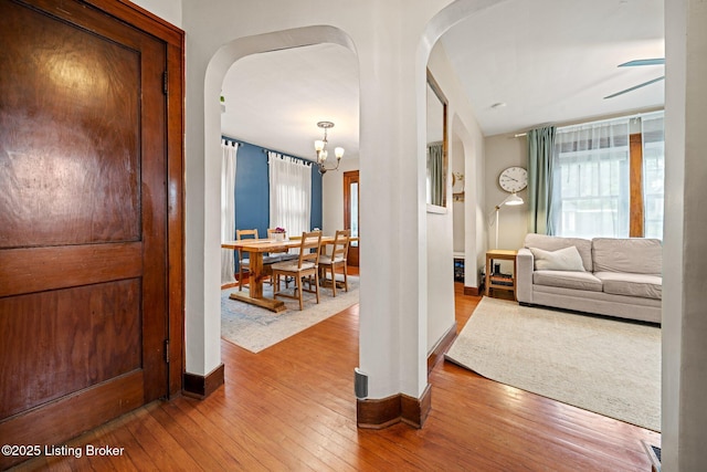 1883 Allgeier Ct, Louisville, KY 40213 - hallway with arched walkways, hardwood / wood-style floors, baseboards, and a chandelier