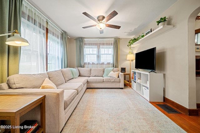 1883 Allgeier Ct, Louisville, KY 40213 - living room with wood finished floors, ceiling fan, arched walkways, and baseboards