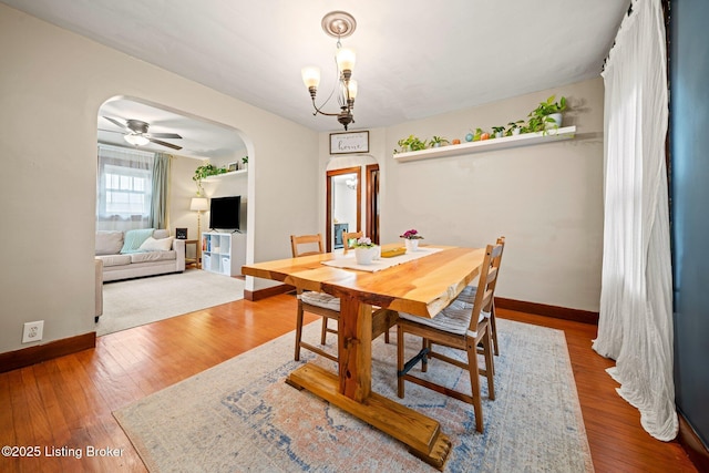 1883 Allgeier Ct, Louisville, KY 40213 - dining room with arched walkways, baseboards, wood finished floors, and a chandelier