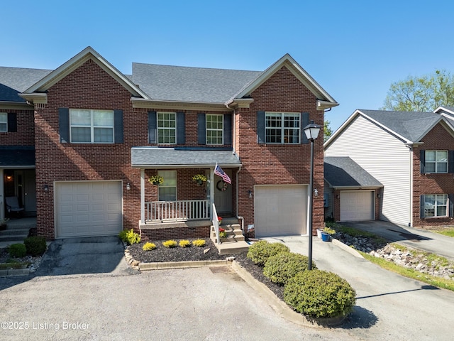 321 Lagrange Villa Dr, La Grange, KY 40031 - view of front of house with covered porch, driveway, brick siding, and a shingled roof