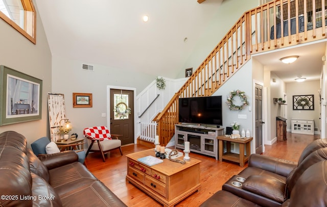 151 Pleasant Railway, Taylorsville, KY 40071 - living room featuring high vaulted ceiling, stairs, light wood-style floors, and baseboards