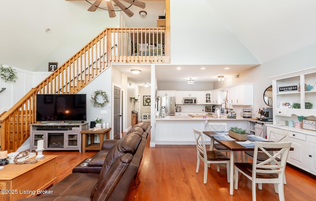 151 Pleasant Railway, Taylorsville, KY 40071 - living area featuring high vaulted ceiling, light wood-type flooring, stairway, ceiling fan, and recessed lighting