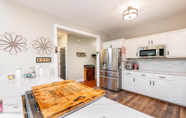 151 Pleasant Railway, Taylorsville, KY 40071 - kitchen featuring appliances with stainless steel finishes, white cabinets, dark wood-style flooring, tasteful backsplash, and baseboards