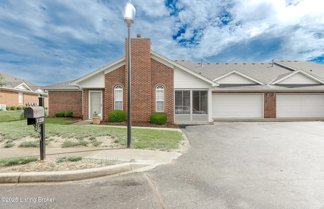 11330 Ridge Lake Dr, Louisville, KY 40272 - view of front of home featuring asphalt driveway, a garage, a chimney, and brick siding