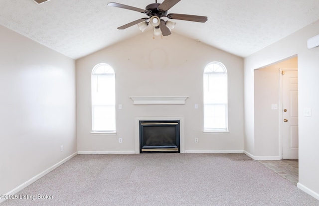 11330 Ridge Lake Dr, Louisville, KY 40272 - unfurnished living room with carpet floors, vaulted ceiling, a ceiling fan, a glass covered fireplace, and baseboards